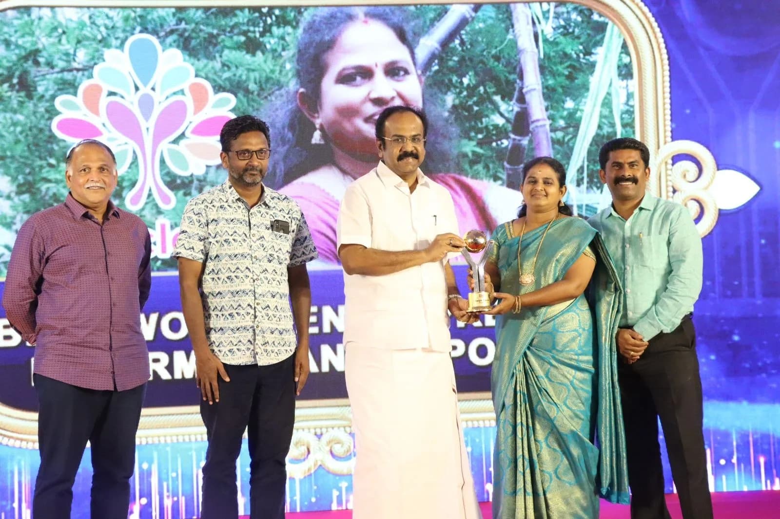 An award being presented on stage at a farming awards ceremony